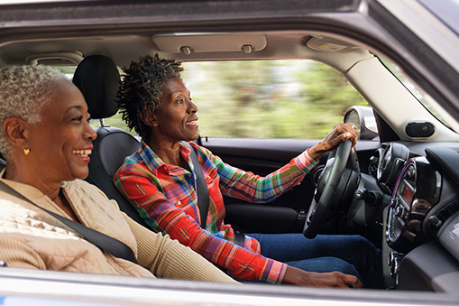 Two people drive in car in North America.